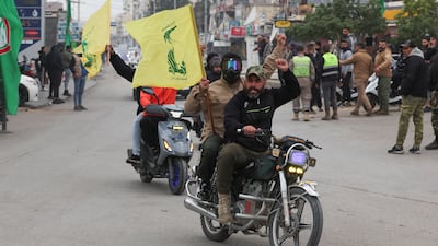 People wave Hezbollah flags in Lebanon's Tyre after a ceasefire between Israel and Hezbollah came into effect on Wednesday. Reuters