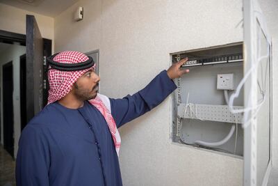 Apartment owner Khaled Salem shows the empty internet supply cable box. Antonie Robertson / The National