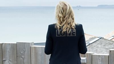 Jill Biden, wearing a Brandon Maxwell jacket with the word 'love' on the back with a Brandon Maxwell dress, in Cornwall, England on June 10, 2021. AFP