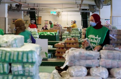 Workers at the Egyptian Food Bank fill boxes with food for families in need. Reuters