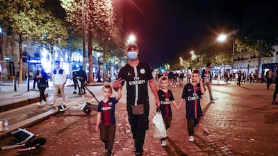 PSG supporters walk on the Champs-Elysees in Paris. AFP