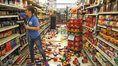 Store employee Talia Pershall, 16, places bottles of syrup back on a shelf while cleaning up at White’s Foodliner grocery store in Pawnee, Oklahoma following a 5.6 magnitude morning earthquake in north-central Oklahoma. The trembler in the edge of the state’s key energy-producing areas rattled the Midwest from Nebraska to North Texas. David Bitton / The News Press via AP