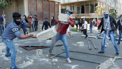Demonstrators throw pieces of concrete during a protest against growing economic hardship in Beirut, Lebanon. REUTERS