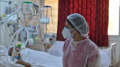 A Tunisian medic attends to patients at a gym that was converted to deal with a surge in new Covid-19 cases in the east-central city of Kairouan.