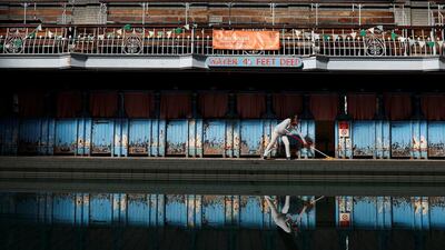 A volunteer sweeps along the pool deck of the Men’s First Class pool before members of the public swim for the first time in more than 20 years inside the partially restored historic Victoria Baths in Manchester, Britain. Phil Noble / Reuters