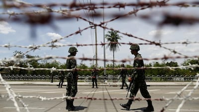 Thai soldiers man a checkpoint near pro-government "red shirt" supporters encampment in suburbs of Bangkok. Thailand's army declared martial law nationwide on May 20, 2014 to restore order after six months of street protests that have left the country without a proper functioning government. Damir Sagolj/Reuters