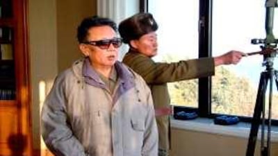 North Korean leader Kim Jong Il, left, inspects a Korean People's Army artillery firing drill at undisclosed location.