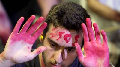 A demonstrator at an anti-government protest in front of the Israeli Defence Ministry in Tel Aviv on Tuesday. AFP