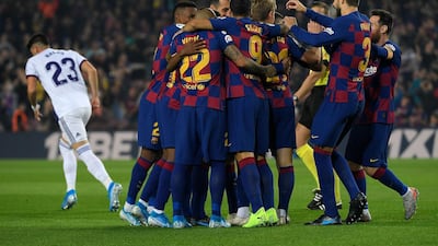 Barcelona's players congratulate French defender Clement Lenglet for scoring the opening goal against Real Valladolid at the Camp Nou stadium in Barcelona on October 29, 2019. / AFP / LLUIS GENE