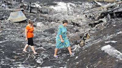 Local residents walk among the wreckage at the site of the crash of a Malaysia Airlines plane carrying 298 people from Amsterdam to Kuala Lumpur in Grabove, in rebel-held east Ukraine. AFP PHOTO/ ALEXANDER KHUDOTEPLY