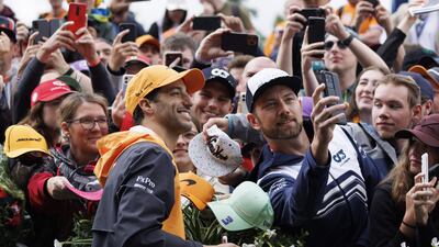 Australian driver Daniel Ricciardo poses for a selfie. AFP