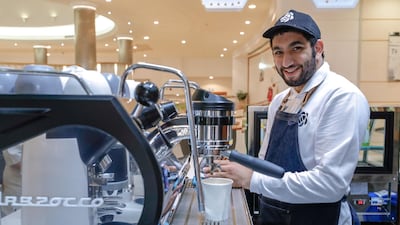Hazza Al Muhairbi behind the counter. Photo: Victor Besa / The National