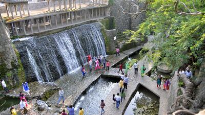 This photo, taken on October 31, 2014, shows Indian visitors in the Rock Garden in Chandigarh, built by self-taught Indian artist and sculptor Nek Chand over the course of 18 years. NARINDER NANU/AFP PHOTO