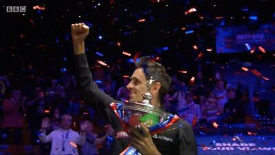 Ronnie O'Sullivan lifting the World Snooker Championship trophy on Sunday. PA