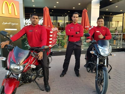 Sanal Pchikaran, Mohammed Zubari and Jhomar Dizon, delivery riders at the McDonald’s branch in Jumeirah, Dubai.