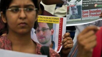 Indian protestors show their support for NSA leaker Edward Snowden at India Gate in New Delhi, India, Sunday, July 7, 2013. Snowden has found supporters in Latin America, including three countries who have offered him asylum. But many obstacles stand in the way of the fugitive NSA leaker from leaving a Russian airport - chief among them the power and influence of the United States. (AP Photo/Tsering Topgyal) *** Local Caption *** India NSA Surveillance.JPEG-03c91.jpg