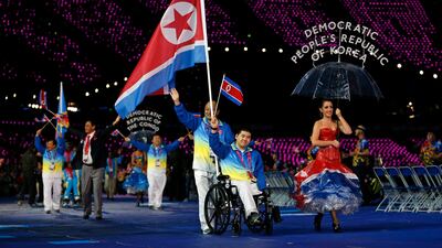 North Korea's flagbearer swimmer Ju Song Rim waves as he enters the arena during the Opening Ceremony for the 2012 Paralympics. Matt Dunham/AP