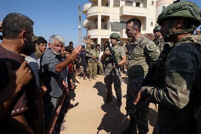 Syrian protesters confront Turkish soldiers during a demonstration against Turkey's perceived inaction over the latest Syrian regime attacks in Idlib. AFP