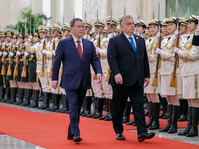 Hungarian Prime Minister Viktor Orban, right, and his Chinese counterpart Li Qiang inspect a guard of honour during a welcome ceremony at the Great Hall of the People in Beijing, on Monday. AP