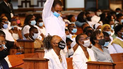 A family member stands and raises his fist. AP
