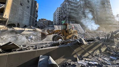 A bulldozer drives along a damaged street in Beirut's southern suburbs. Reuters