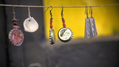 Items on display in Hilu's workshop, including earrings made from bottle caps. Heidi Levine for The National).