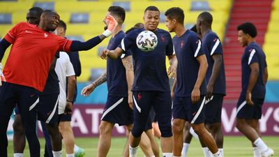 France goalkeeper Steve Mandanda and Kylian Mbappe (C) attend a training session at the Allianz Arena. AFP