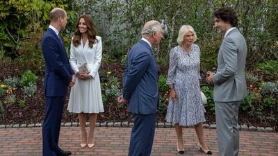 The Duchess of Cambridge arrived at the event wearing a crisp white, semi-fitted Alexander McQueen coat dress, snugly tailored through the torso, before fanning out into knife pleats. AFP