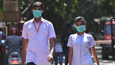 Medical staff leave a hospital in Mumbai wearing face masks. India has 73 confirmed coronavirus patients and the government has advised citizens against travel overseas. AFP