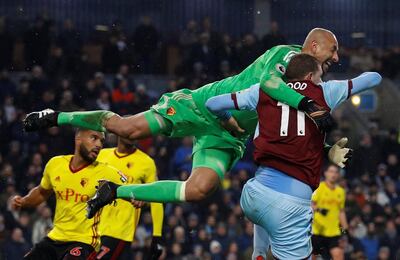 Burnley’s Chris Wood in action with Watford goalkeeper Heurelho Gomes. Phil Noble / Reuters