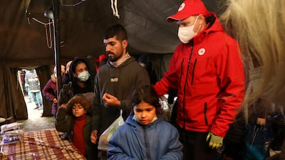 Migrants receive food inside a Red Cross tent in Belarus. AP Photo