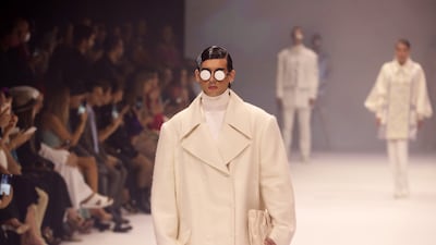 A model shows off an oversized coat look from Michael Cinco.