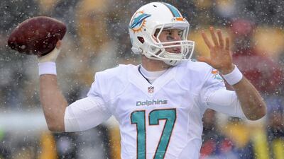 Miami quarterback Ryan Tannehill attempts to throw in the snow. A native of Texas in his second year as a pro with the Dolphins, Tannehill had never played in the snow before Sunday. Don Wright / AP