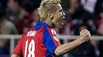 Keisuke Honda celebrates scoring against Sevilla in the second leg of their last-16 Champions League tie earlier this month.