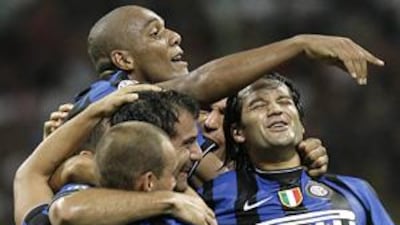 Inter Milan's Dejan Stankovic, centre, celebrates with his teammates after scoring the fourth goal against AC at the San Siro.