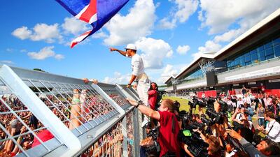 Mercedes-GP driver Lewis Hamilton of Great Britain celebrates with the fans after his victory in the British Grand Prix at Silverstone on July 6, 2014, in Northampton, United Kingdom. Mark Thompson / Getty Images