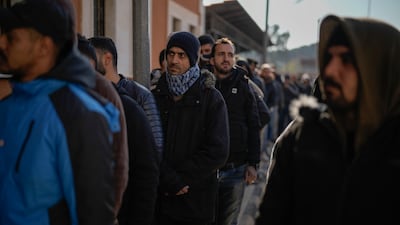 Members of the Syrian army line up to register with rebels as part of an "identification and reconciliation process" at an army compound in Latakia. AP Photo
