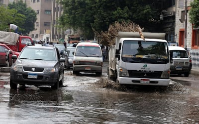 Cars drive through a flooded street after a flash flood affected Cairo, Egypt. Khaled Elfiqi / EPA