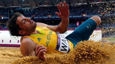 Australian athlete Mitchell Watt lands during the men's long jump event at London 2012