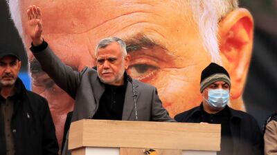 Hadi Al Amiri, centre, head of Badr Organisation, waves to his supporters during the rally, held in the Iraqi capital. Members and supporters the Popular Mobilisation Forces, a group of Shiite militias in Iraq, attended a rally to commemorate Suleimani and Al Muhandis, who died on January 3, 2020. EPA