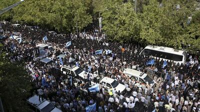 Thousands of mourners attend a funeral ceremony in Tehran on Sunday for some of the Iranian pilgrims who were killed in last month's Haj stampede. Vahid Salemi/AP Photo