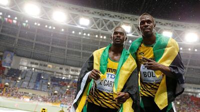 Usain Bolt, right, and his 4x100m Jamaica teammates, Michael Frater and Asafa Powell, may need to give up their Beijing 2008 gold medals after Nestra Carter, left, failed a doping test. Dominic Ebenbichler / AFP
