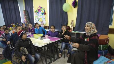 Teacher Hanan Al Hroub addresses her class of mostly seven-year-olds on her first day back at Samiha Khalil school, just outside Ramallah, after winning the second annual $1 million (Dh3.67m) Varkey Foundation Global Teacher Prize earlier in the month. Heidi Levine for The National