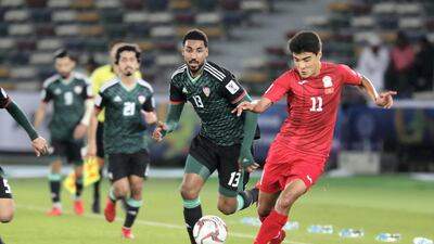 Sagynbaev Bekzhan, right, of Kyrgyzstan runs with the ball.