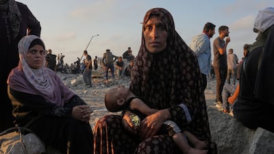 A mother and child waiting for humanitarian aid to arrive in Gaza city. AP Photo