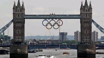 The Olympic rings are seen atop the iconic Tower Bridge over river Thames in London, after they were lowered into position, coinciding with one month to go until the start of London 2012 Games, Wednesday, June 27, 2012. The giant rings, which are fully retractable to allow for tall ships to pass through the bridge, will remain in position for the duration of the Games. (AP Photo/Lefteris Pitarakis) *** Local Caption *** Britain London 2012 Olympics.JPEG-09e02.jpg