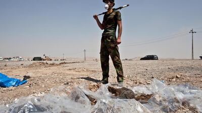 A Shiite militiaman stands over the exhumed bodies of five civilians who were killed by ISIL militants. Although Shiite militias play a key role in the fight against ISIL, they also challenge government authority and threaten to perpetuate sectarian violence. The Washington Post