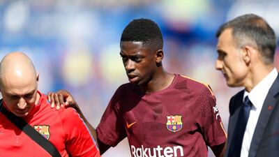 Barcelona's Ousmane Dembele, centre, leaves the pitch injured during the match against Getafe, a match Barca won 2-1. Francisco Seco / AP Photo