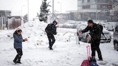 Playing in the snow in Istanbul. Schools were closed due to severe weather conditions. AP