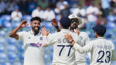 India's Mohammed Siraj, left, celebrates the dismissal of West Indies' opener Tagenarine Chanderpaul for 10. AP
